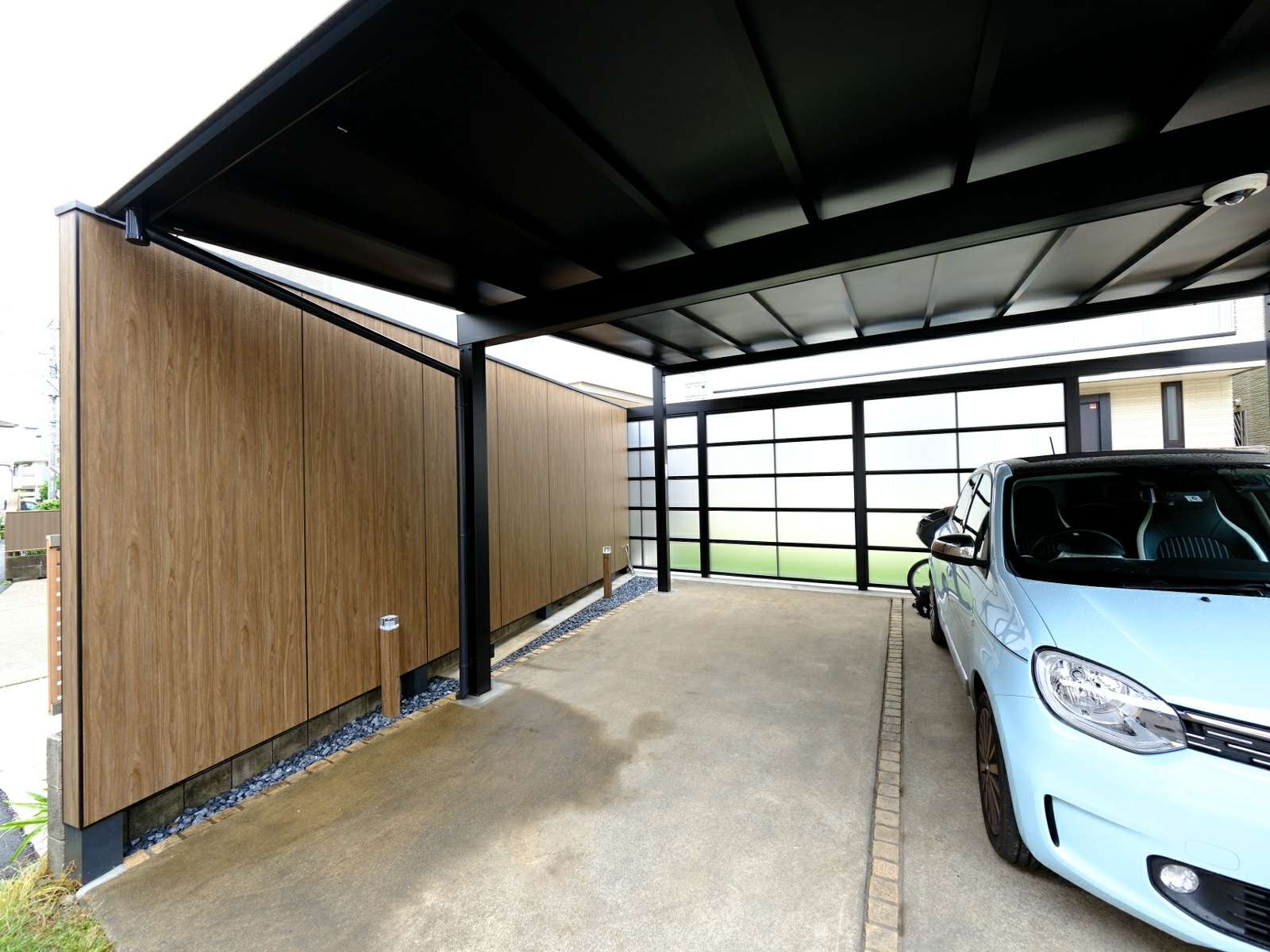 防犯カメラと外構照明が設置されたスタイリッシュでおしゃれな車庫周り