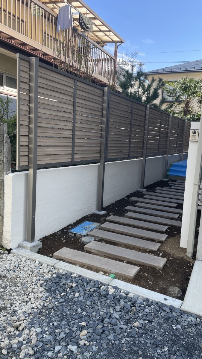 境界側に設置された高さ1.2mのアルミ目隠しフェンスと頑丈な多段柱