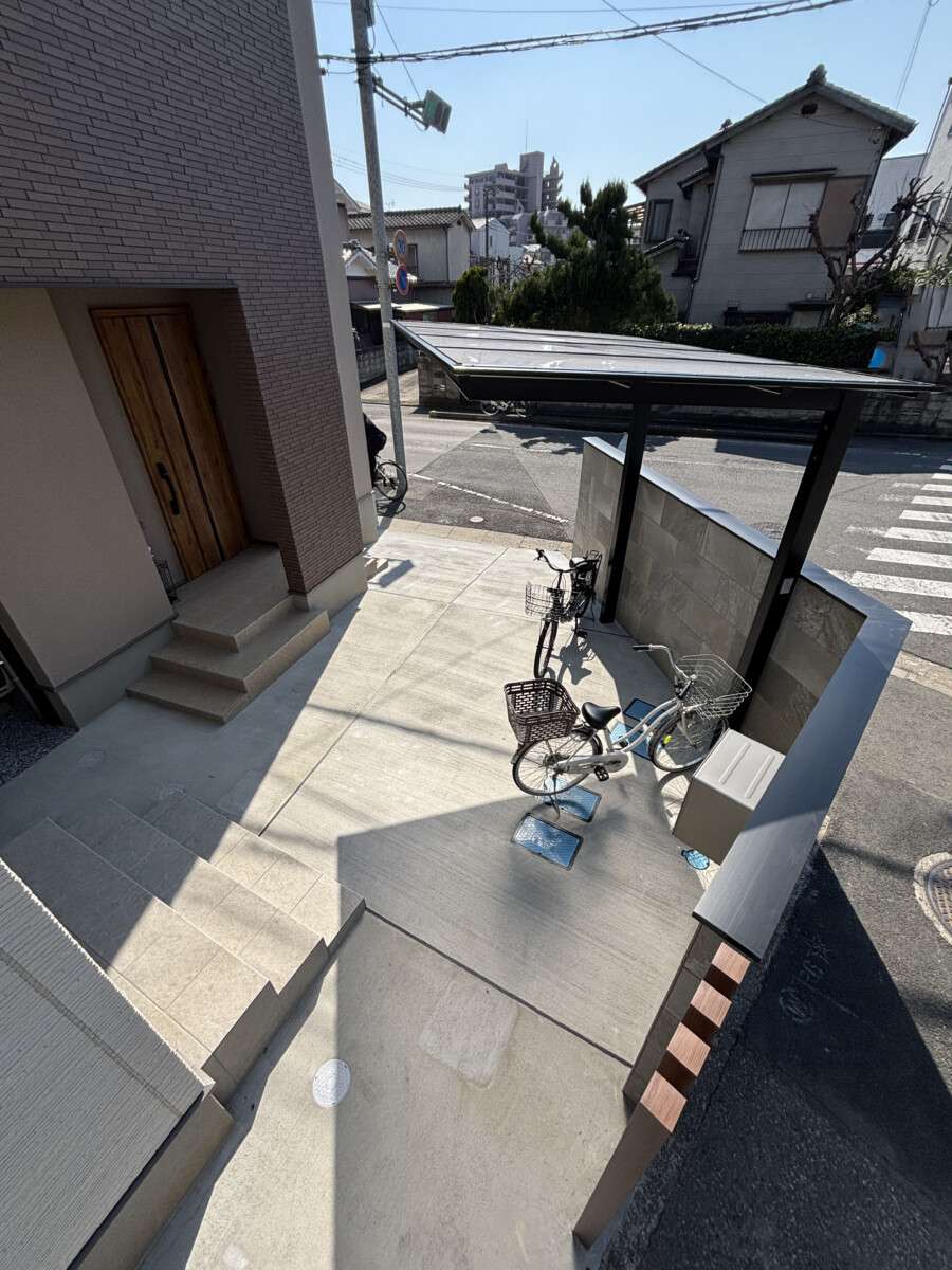 塀で区切られた駐輪スペース、門柱と一体化したデザイン